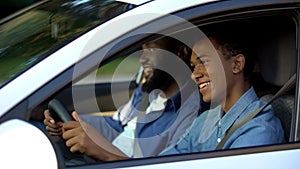Male examiner pleased with young male passing driving test, support and help