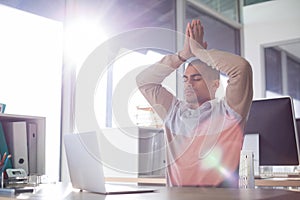 Male executive doing yoga