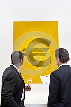 Male executive looking at Euro sign over white background