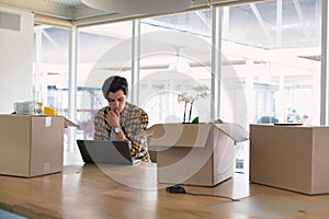 Male executive using laptop in the conference room