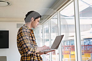 Male executive using laptop in the conference room at office