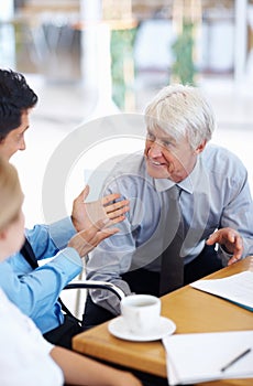 Male executives with business woman in conversation. Portrait of male executives having happy conversation with female