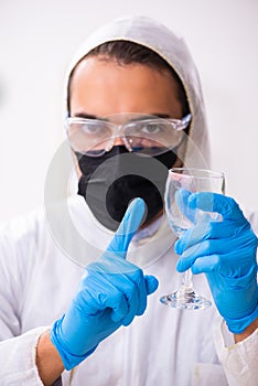 Male expert criminologist working in the lab for evidence