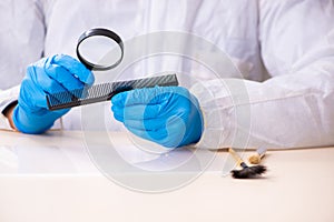 Male expert criminologist working in the lab for evidence