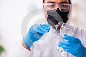 Male expert criminologist working in the lab for evidence