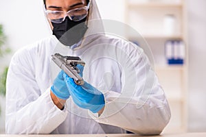 Male expert criminologist working in the lab for evidence