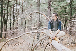 Male explorer rests in the woods.