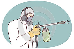 Male exterminator spraying pesticide