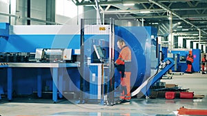 Male factory worker operating a complex modern machine