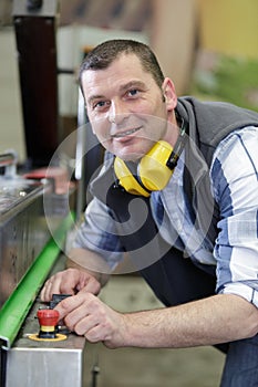 Male factory worker smiling at camera