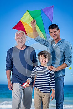 Male family members playing with a kite