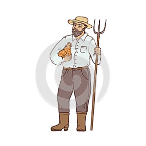 Male farmer in boots and wide-brimmed straw hat, with chicken and a pitchfork in his hands. Worker in the agricultural