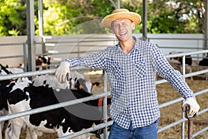 Male farmer posing at cowshed on farm