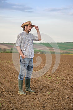 Male Farmer Standing on Fertile Agricultural Farm Land Soil