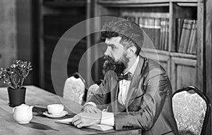 Male fashion, luxury style, work, success, business concept. Bearded man in formal suit with cup of tea.