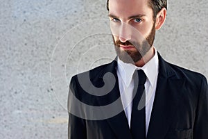 Male fashion model in black suit and tie