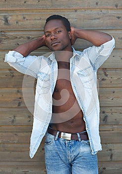 Male fashion model relaxing with hands behind head