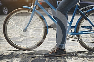 Male feet pedaling bike outside