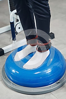 Male feet put on fitness training device at gym