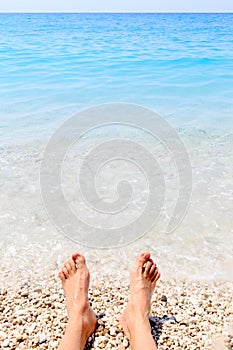 Male feet and summer sea