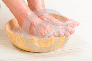 Male feets in a bowl