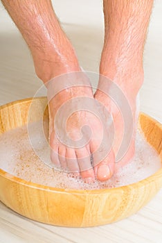 Male feets in a bowl