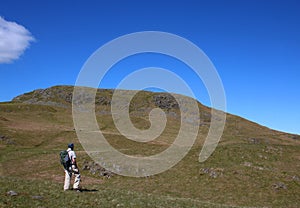 Male fellwalker on slopes of Hallin Fell, Cumbria