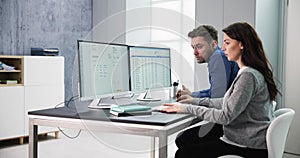 Male And Female Auditors Working On Computer With Invoice