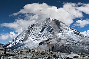 Male and female backpacker trekking through the Andes in Peru and admiring the view