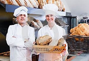 Male and female bakers 30-35 years old are with tasty and fresh
