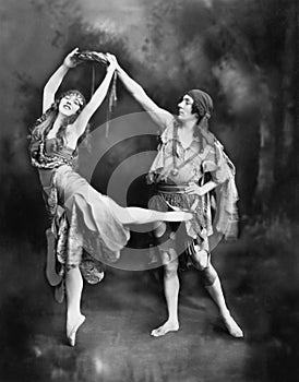 Male and female ballet dancers performing in costume