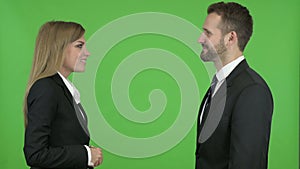 Male and Female Business Professionals Shaking Hands Against Chroma Key