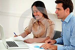 Male and female colleagues working on documents