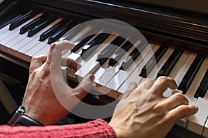 Male and female couple playing the piano together