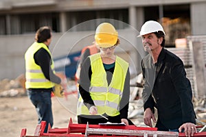 Male and female coworkers on construction site