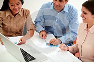 Male and female coworkers working on documents