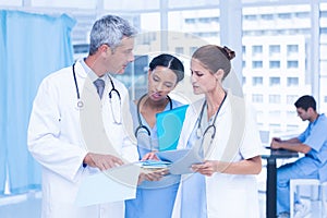 Male and female doctors working on reports