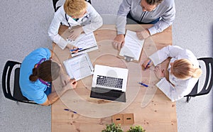 Male and female doctors working on reports in