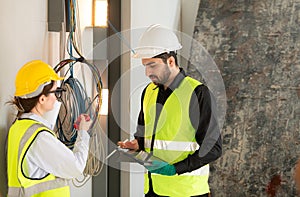 Male and female engineers working on construction site,
