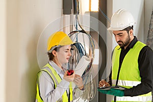 Male and female engineers working on construction site