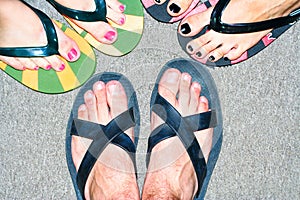 Male and female feet in slippers