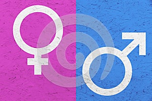 Male and female gender symbols Mars and Venus signs over pink and blue uneven texture background.