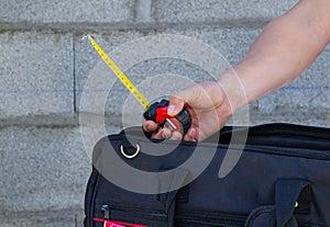 Male and female hands with building materials