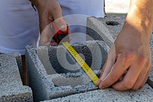 Male and female hands with building materials