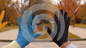 Male and female hands in latex gloves