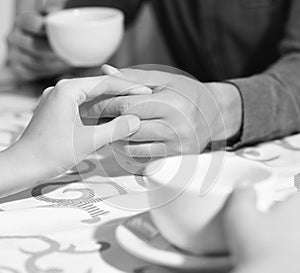 Male and female hands on table. Rendezvous and coffee break