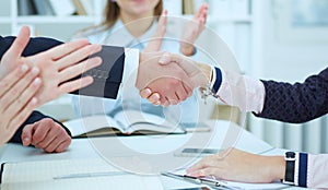 Male and female handshake in office.