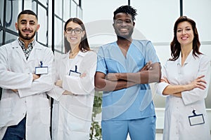 male and female healthcare workers standing in corridor at hospital