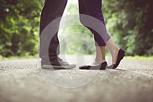 Male and female legs and black shoes, vintage tone