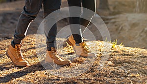 Male and female legs walking by forest